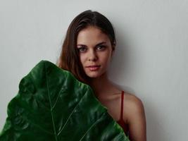 woman in red swimsuit palm leaf Exotic attractive look photo