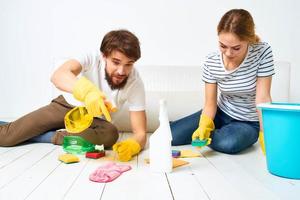 Young couple detergent washing the floor working together lifestyle photo