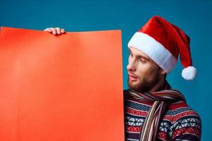 Cheerful man in New Year's clothes advertising copy space studio posing photo