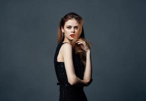 red-haired lady in a black dress gesturing with her hands hugs emotions makeup model photo