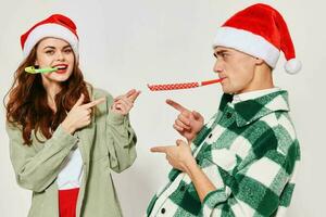 Cheerful young couple New Years holiday caps fun fashion photo