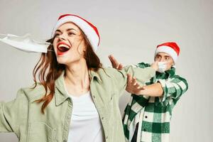 Cheerful woman and man medical masks Christmas holidays fun emotions photo