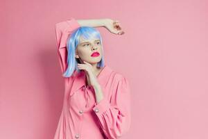 female wears a blue wig makeup pink background photo