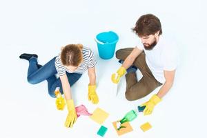 young couple washing floors cleaning supplies cleaning together homework photo