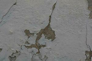 background of old colorful wall with cracked plaster in close-up photo