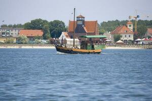 summer view from the sea of the city of Hel in Poland with a ship in the background photo