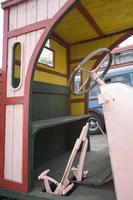 antique wooden car forming a mechanical background in a museum photo