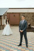 the first meeting of the bride and groom in the courtyard of the hotel photo