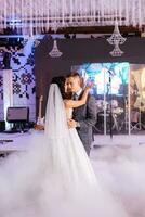 the first dance of the bride and groom inside a restaurant photo