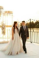 bride and groom against the backdrop of a yellow sunset photo