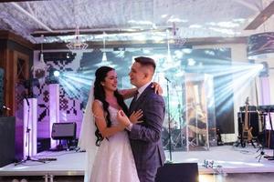 the first dance of the bride and groom inside a restaurant photo