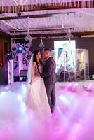 the first dance of the bride and groom inside a restaurant photo