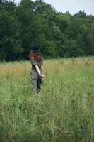 Woman on nature Walking through the field fresh air travel back view photo