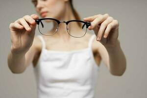 woman glasses in the hands of astigmatism studio treatment photo