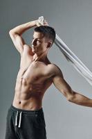 sporty man with pumped towel press behind head workout bodybuilder photo