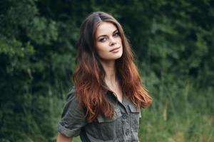 Portrait of a woman nature Look forward in the forest against the background of trees photo