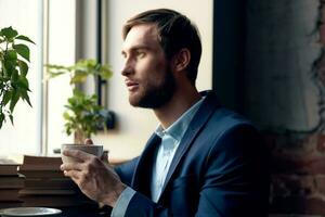 man in a suit with a cup of coffee in his hands breakfast lifestyle leisure photo