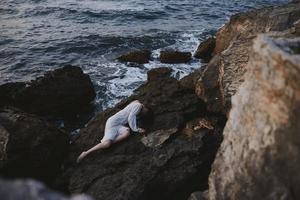 woman in white wedding dress on sea shore wet hair view from above photo