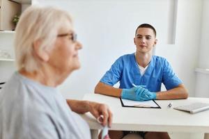 an elderly woman is examined by a doctor professional consultant photo