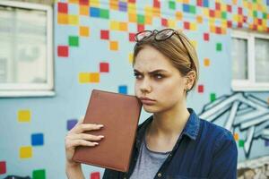 Business woman with notepad in hands outdoors building walk lifestyle photo