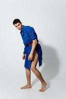 man in a blue dress on a light background gay model photo