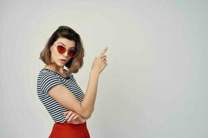 woman wearing sunglasses gesturing with hands luxury summer fashion photo