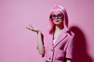 Portrait of a young woman gestures with his hands with a pink jacket Studio Model unaltered photo