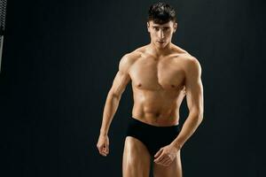 Attractive Athletic Man In Dark Briefs Studio Posing photo