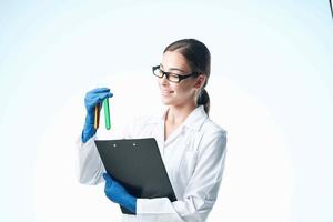 Woman in white coat laboratory research chemical solution analyzes photo