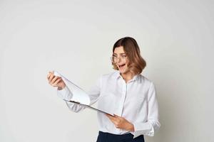Business woman in white shirt papers emotions light background photo