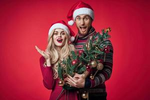 Cheerful man and woman Christmas tree decoration toys romance photo