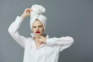 woman with a towel on his head in a white shirt isolated background photo