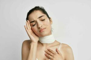 sick woman bandaged neck negative headache isolated background photo