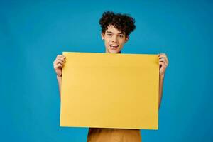 curly guy with yellow mockup poster blue background photo