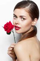 Lady with rose Look forward on bare shoulders red lips photo