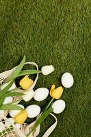 bunch of flowers easter eggs lie on the green lawn holiday tradition decoration photo
