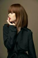 Beige background attractive woman European appearance coat photo