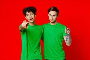 Two cheerful friends hug green t-shirts emotions photo