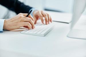 keyboard on desktop hands typing close up photo