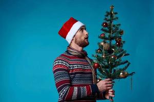 Cheerful man in a santa hat holding a banner holiday studio posing photo