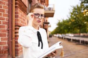 student on the street near the building rest communication photo