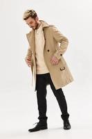 handsome man in coat hang hands in pockets fashion posing autumn style photo