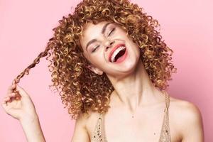 Pretty woman curly hair Fun closed eyes red lips close-up photo