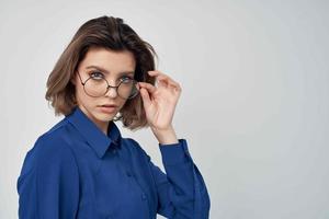 woman in blue shirt fashion posing light background photo