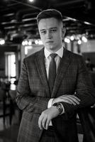 portrait of a groom in a gray plaid suit with a tie photo