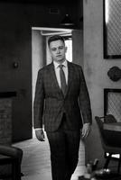 portrait of a groom in a gray plaid suit with a tie photo