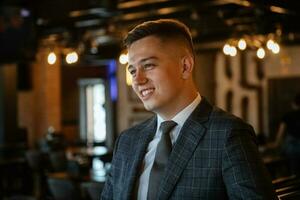 portrait of a groom in a gray plaid suit with a tie photo