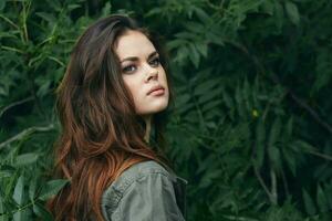 Woman outdoors confident look Green shirt trees photo