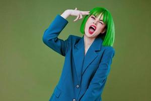 Pretty young female Glamor green wig red lips blue jacket color background unaltered photo