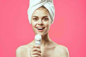 woman with towel on head naked shoulders massager dermatology spa treatments photo